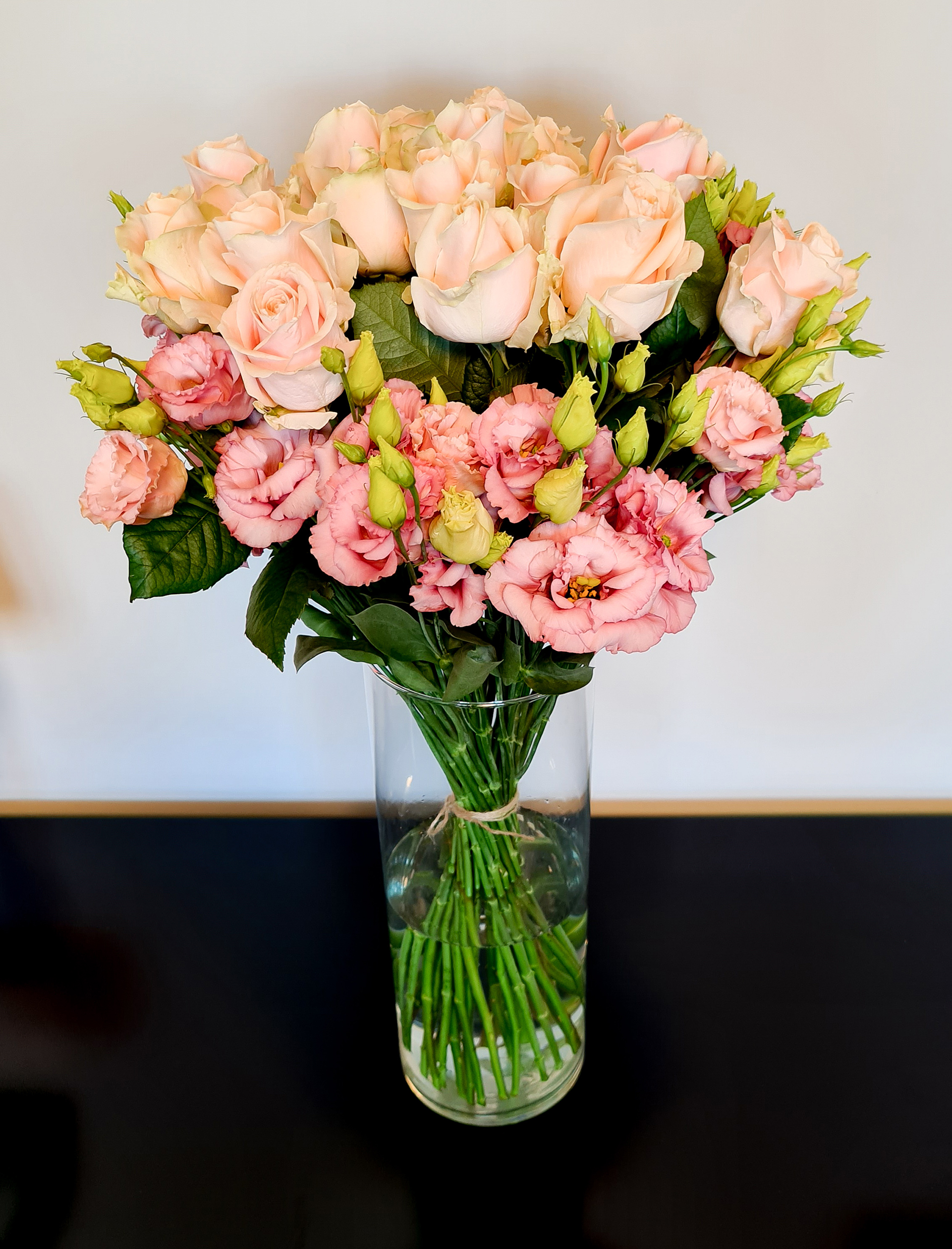 lachsfarbene Rosen mit rosa Lisianthus
